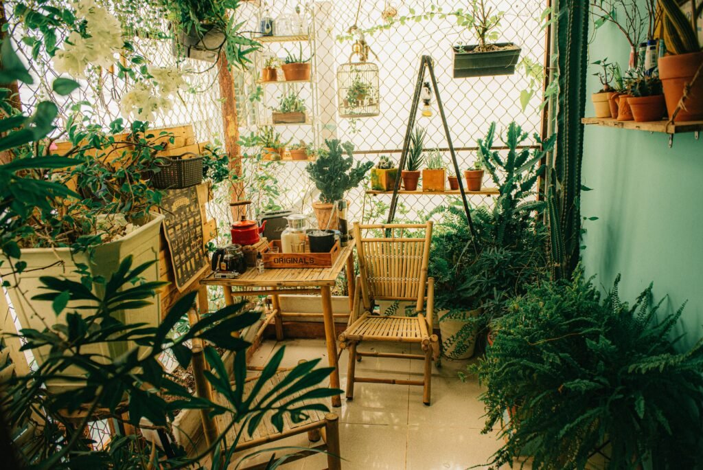 Lush apartment balcony garden filled with potted plants and hanging greenery